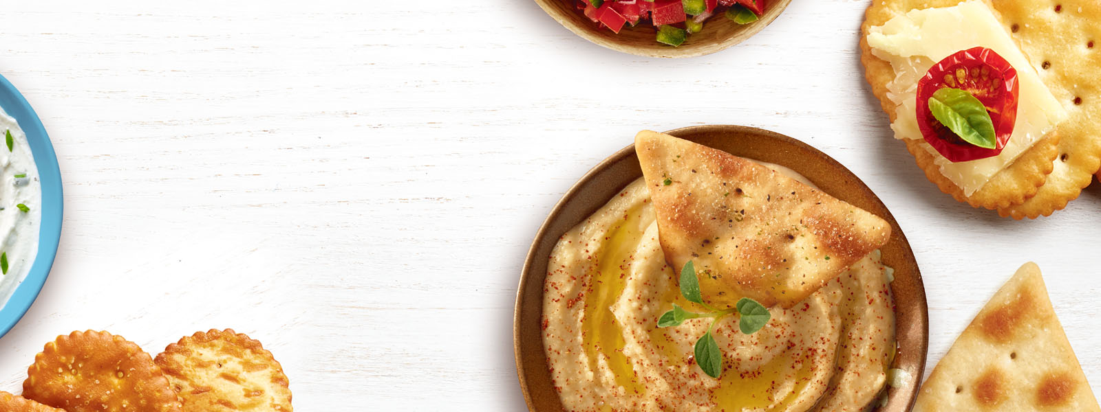 Townhouse Crackers arranged with cheese and tomatoes.